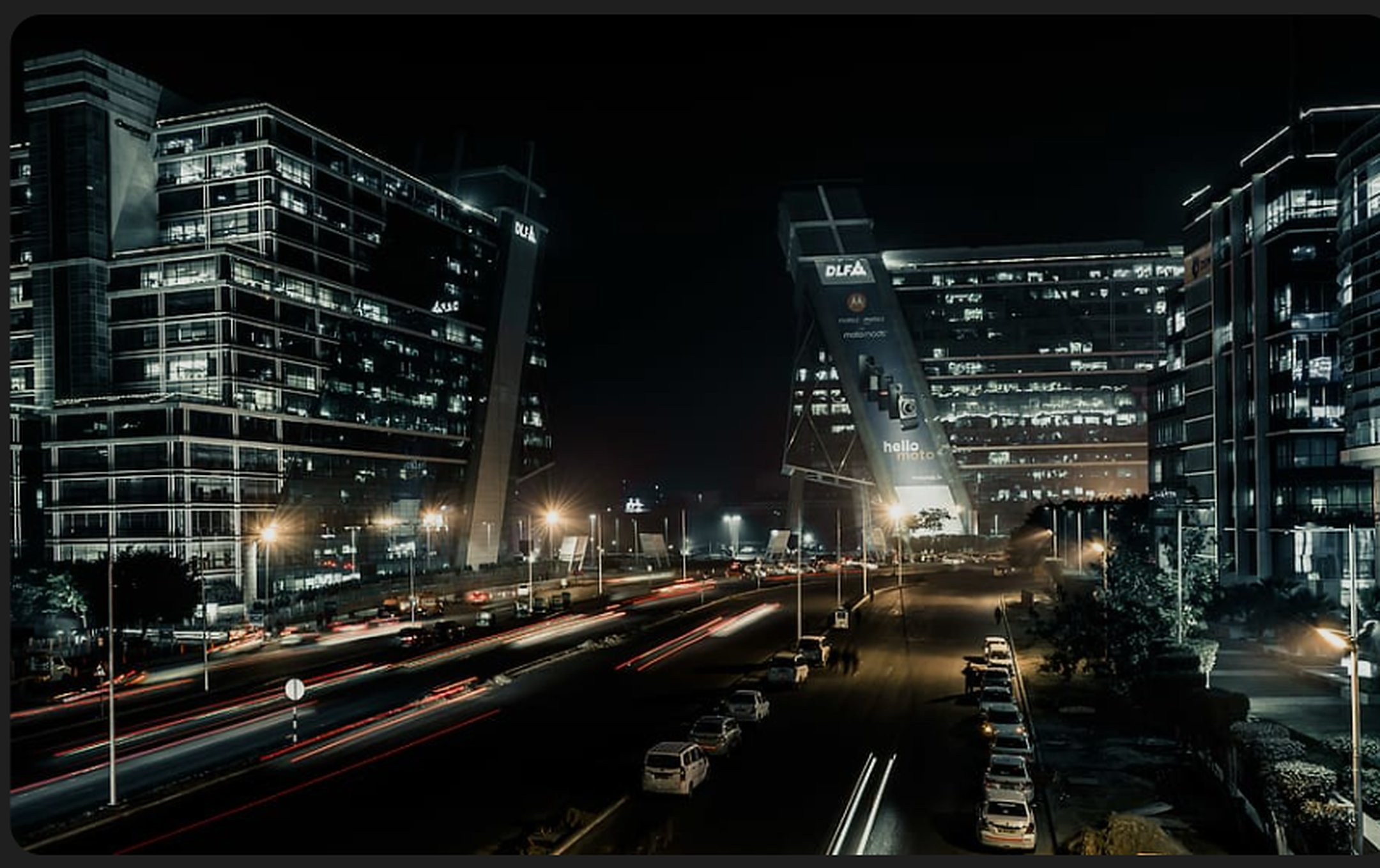 DLF Cyber City Gurgaon at night — luxury skyline with light trails